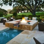 A fire pit in the middle of an outdoor pool.