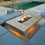 A fire pit sitting next to the pool.