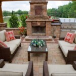 A patio with furniture and an outdoor fireplace.
