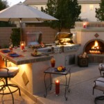 A patio with an outdoor grill and fire place