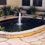 A fountain in the middle of a patio area.