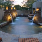 A pool with water jets and lights in the middle of it