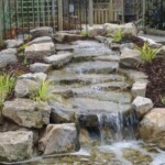 A waterfall that is made of rocks and water.