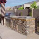 A grill and an oven in the middle of a patio.