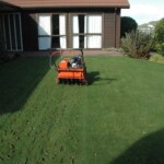 A lawn mower sitting in the middle of a yard.