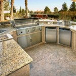 A large outdoor kitchen with granite counter tops.