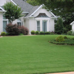 A house with green grass in front of it.