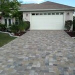A driveway with a white door and a house