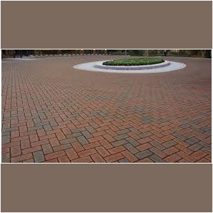 A brick walkway with a circular pattern in the center.