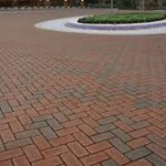A brick walkway with a circular pattern in the center.