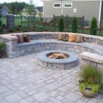 A fire pit sitting in the middle of an outdoor patio.