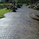 A walkway with brick and stone patterns in the middle of it.