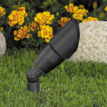 A black light in the grass near some rocks